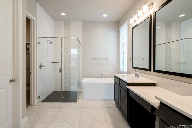 a bathroom with a sink a mirror and a bathtub