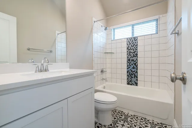 a bathroom with a sink vanity and mirror