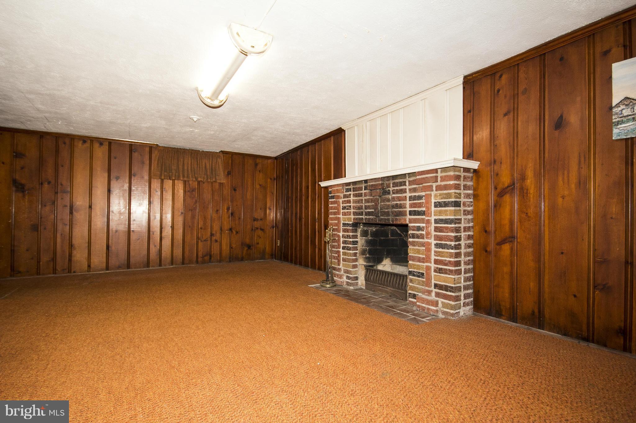6911 Kenleigh Road Baltimore, MD 21212 - Photo 13 of 26 a view of an empty room with a fireplace