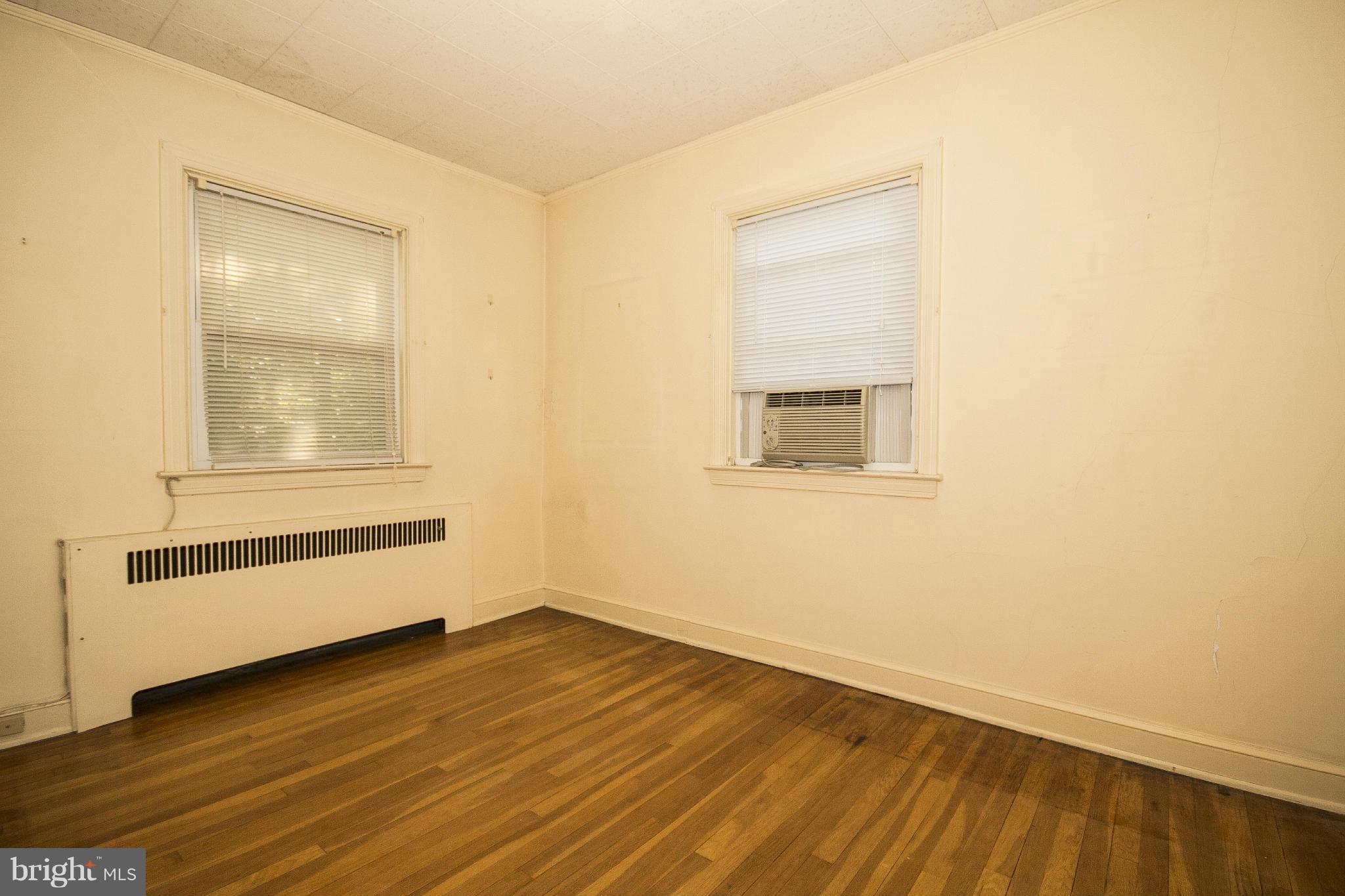6911 Kenleigh Road Baltimore, MD 21212 - Photo 17 of 26 an empty room with wooden floor and windows