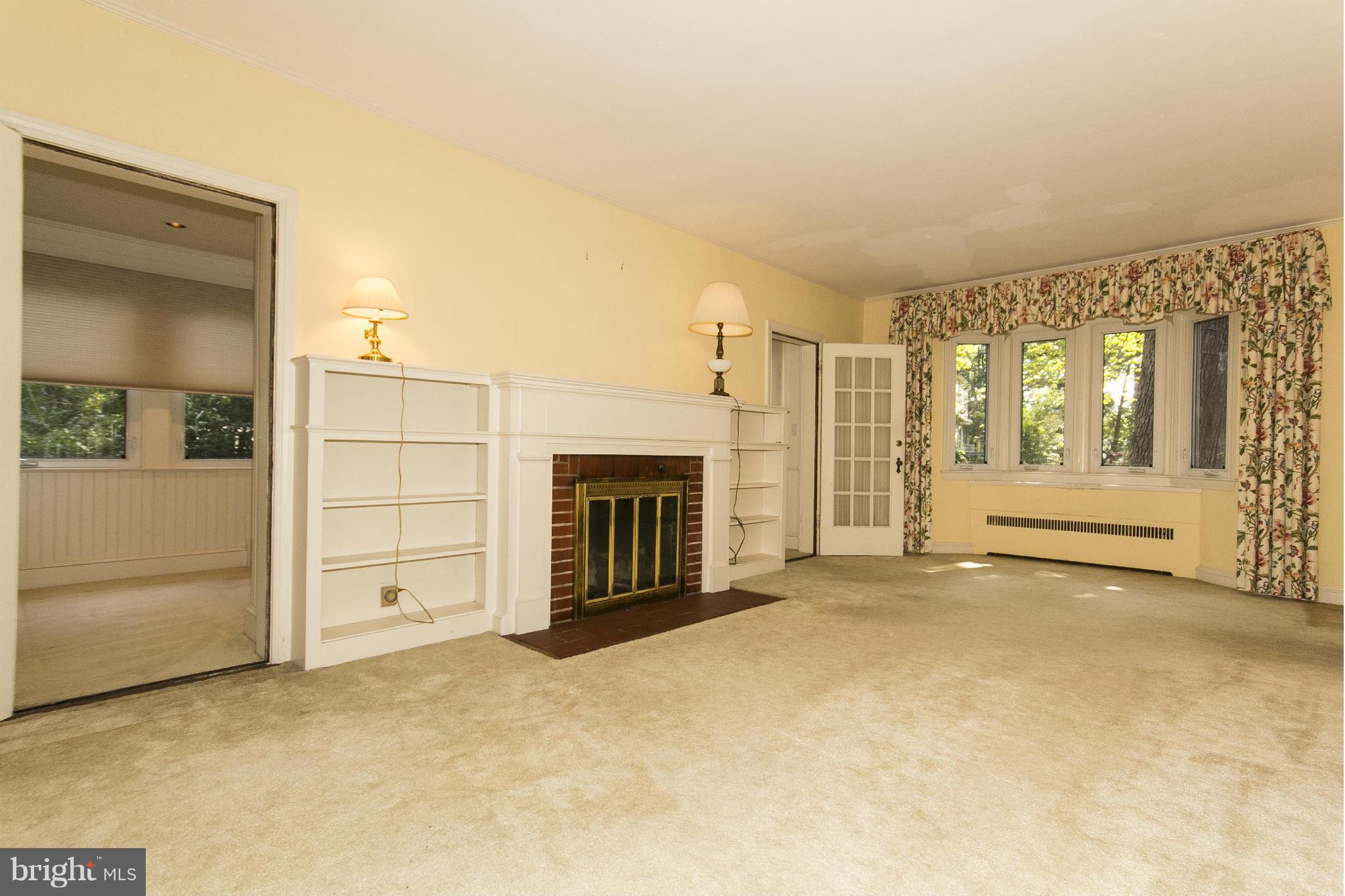 6911 Kenleigh Road Baltimore, MD 21212 - Photo 3 of 26 an empty room with fireplace and windows