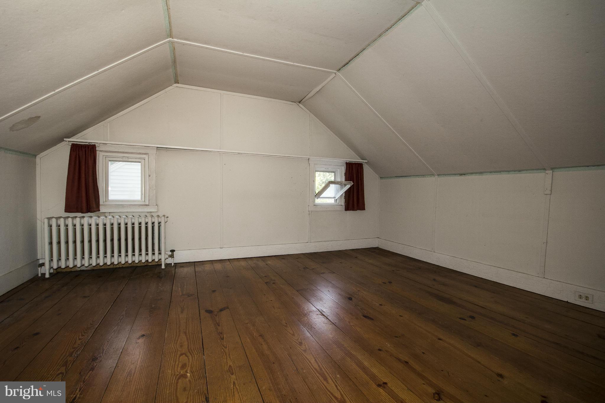 6911 Kenleigh Road Baltimore, MD 21212 - Photo 21 of 26 an empty room with wooden floor and windows