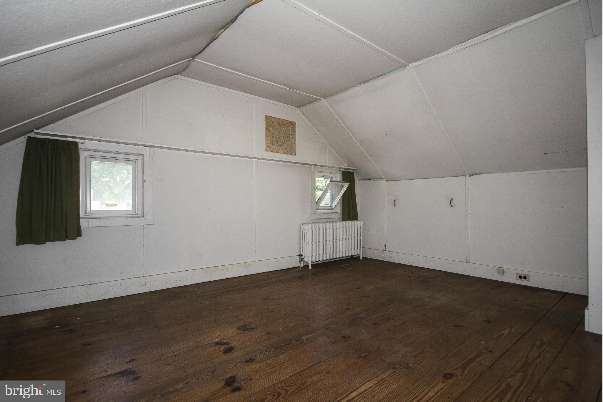 6911 Kenleigh Road Baltimore, MD 21212 - Photo 22 of 26 an empty room with wooden floor and windows