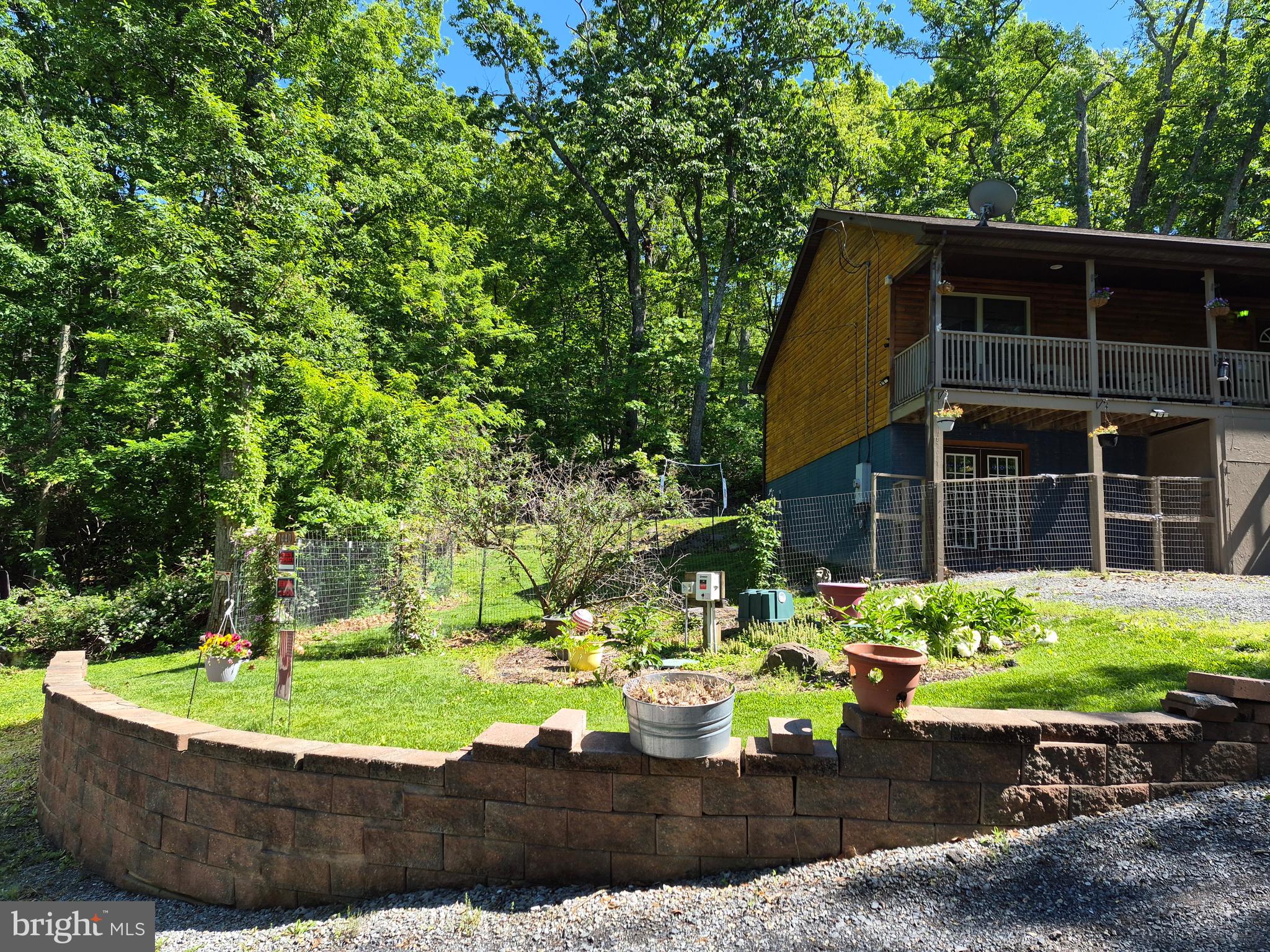 1440 Drummer Hill Road Front Royal, VA 22630 - Photo 5 of 42 a view of a backyard with table and chairs potted plants