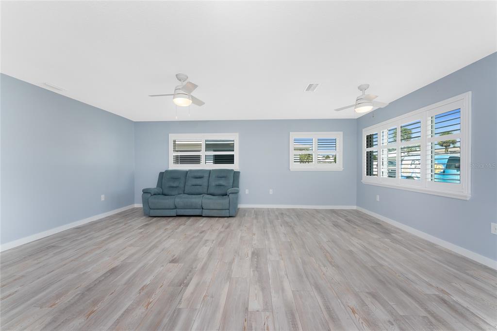 1977 Beach Road, Unit 3 Englewood, FL 34223 - Photo 11 of 56 a view of empty room with wooden floor and fan