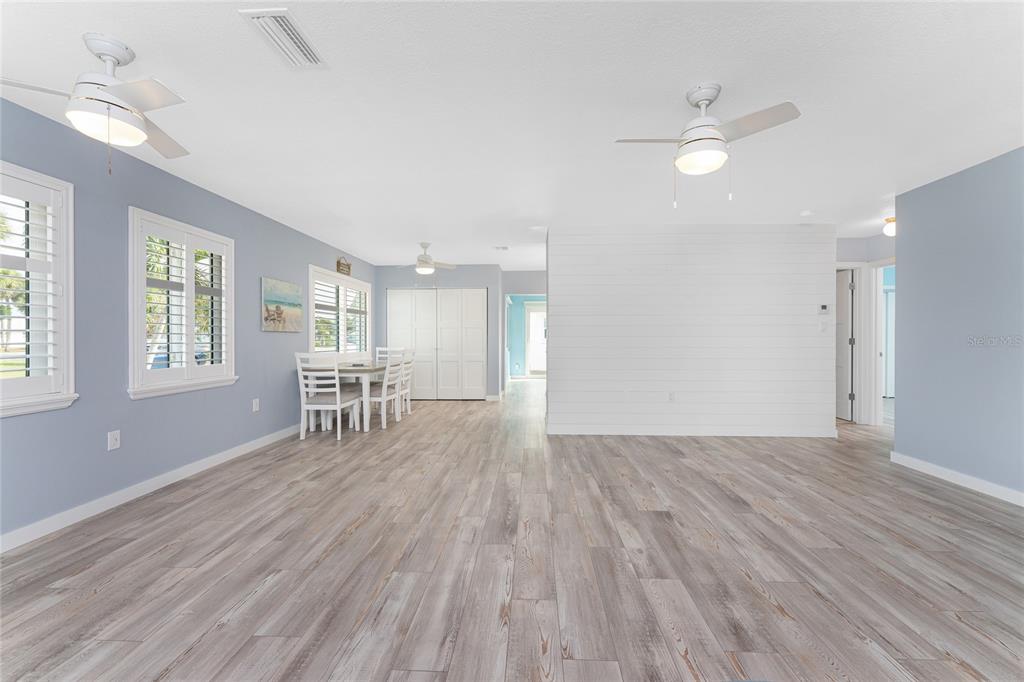 1977 Beach Road, Unit 3 Englewood, FL 34223 - Photo 15 of 56 an empty room with wooden floor and windows