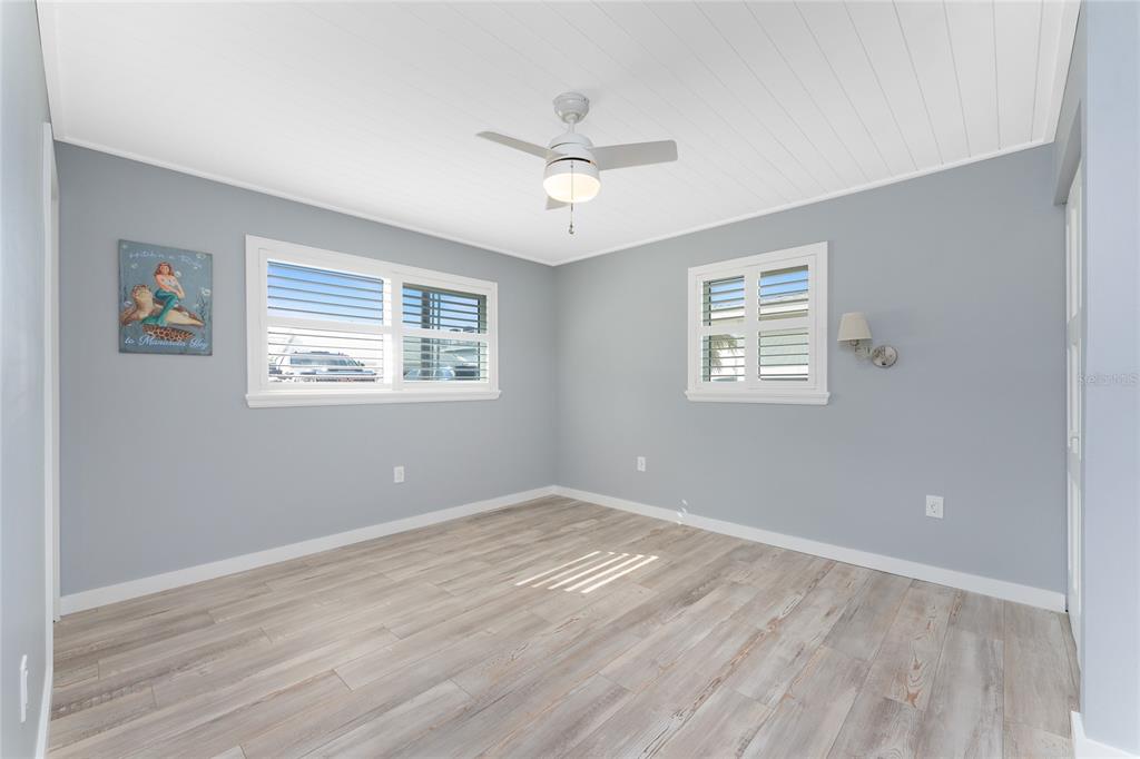 1977 Beach Road, Unit 3 Englewood, FL 34223 - Photo 29 of 56 a view of empty room with wooden floor and fan
