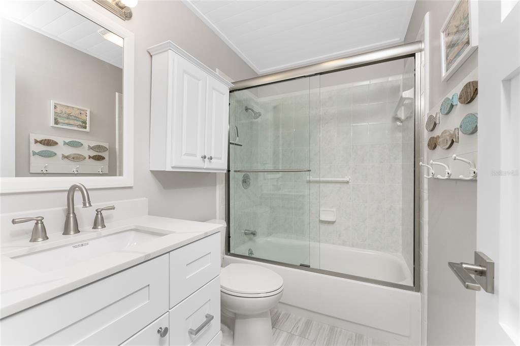 1977 Beach Road, Unit 3 Englewood, FL 34223 - Photo 42 of 56 a bathroom with a shower sink vanity mirror and toilet