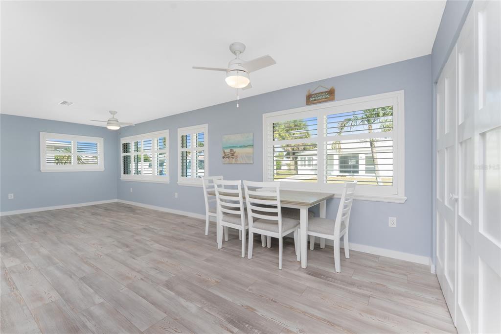 1977 Beach Road, Unit 3 Englewood, FL 34223 - Photo 9 of 56 a dining room with wooden floor and a window