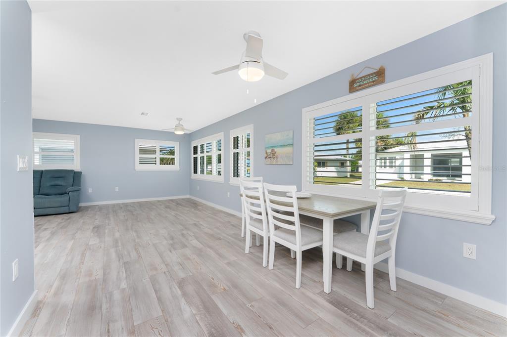 1977 Beach Road, Unit 3 Englewood, FL 34223 - Photo 10 of 56 a dining room with furniture and wooden floor