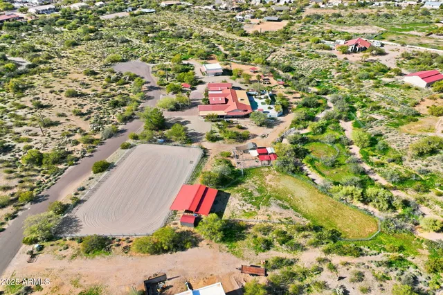an aerial view of residential houses with outdoor space and street view