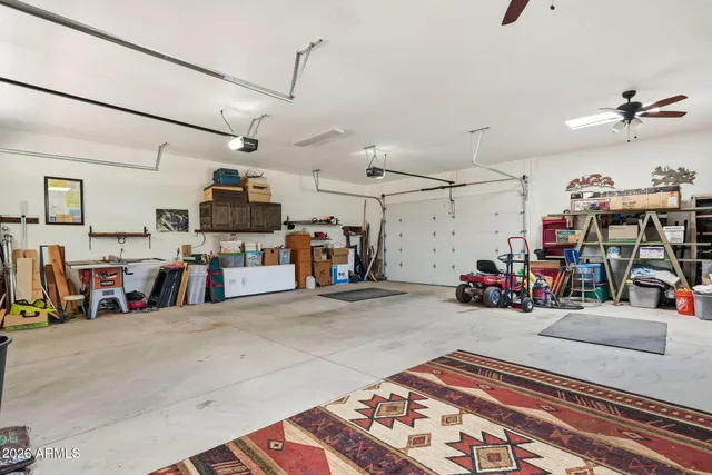 a living room with stainless steel appliances kitchen island granite countertop furniture a rug and a window