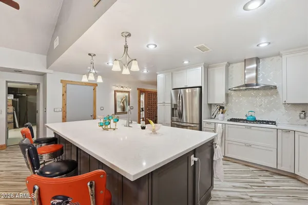 a living room with furniture a ceiling fan and a rug