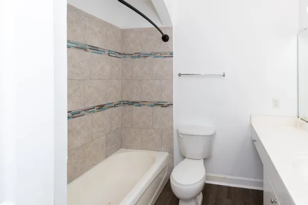 a white toilet sitting next to a bathroom sink and a shower