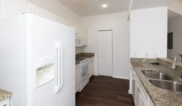 a kitchen with a refrigerator sink and stove