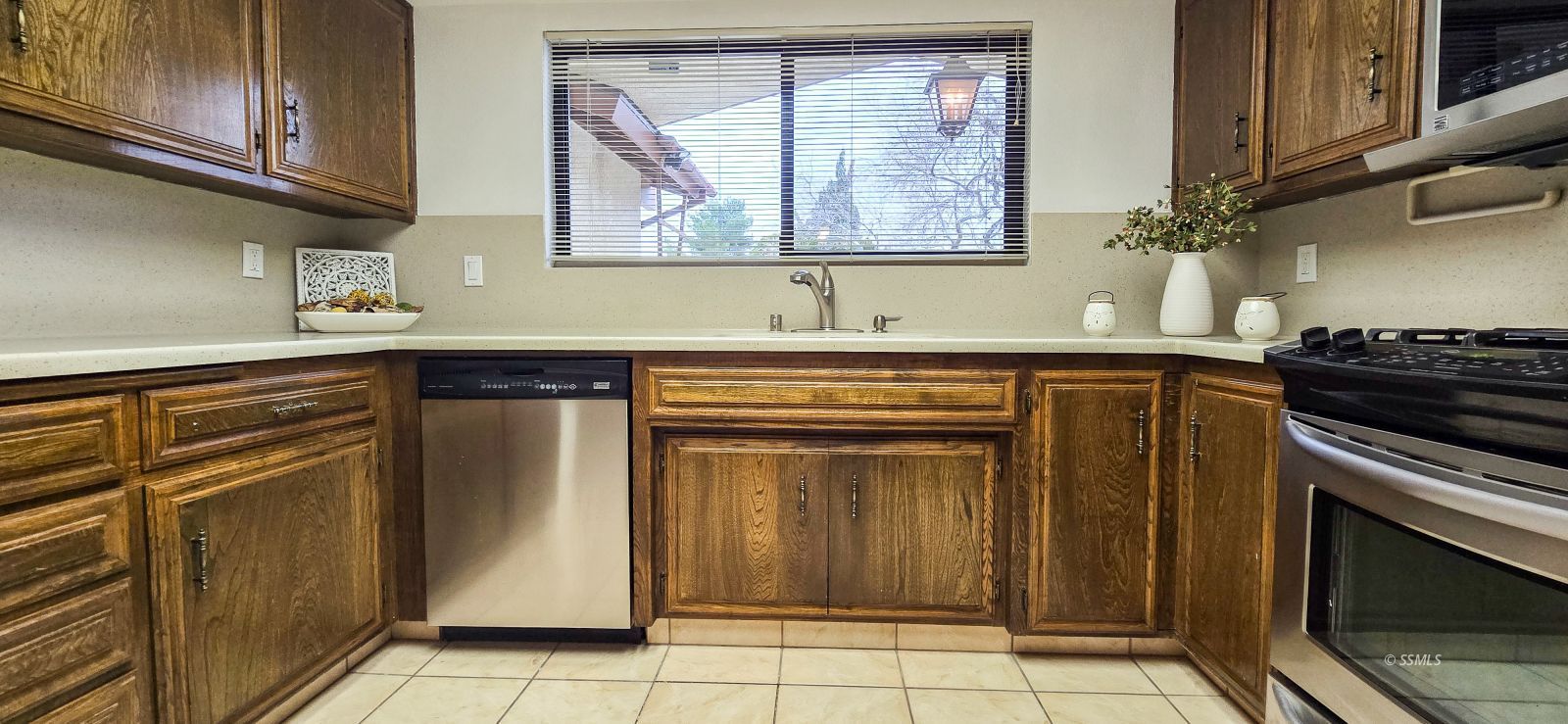 441 Cheyenne Circle Ridgecrest, CA 93555 - Photo 14 of 34 a kitchen with stainless steel appliances granite countertop a stove a sink and a microwave