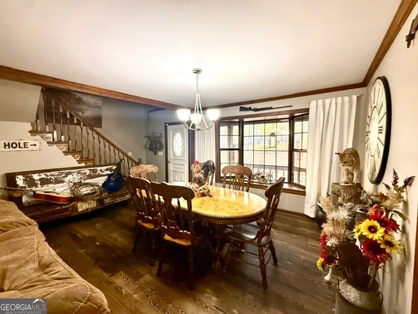 a view of a dining room with furniture and a chandelier