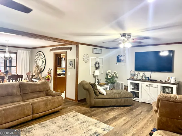 a living room with furniture flat screen tv and couches