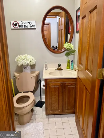 a bathroom with a toilet a sink and a mirror