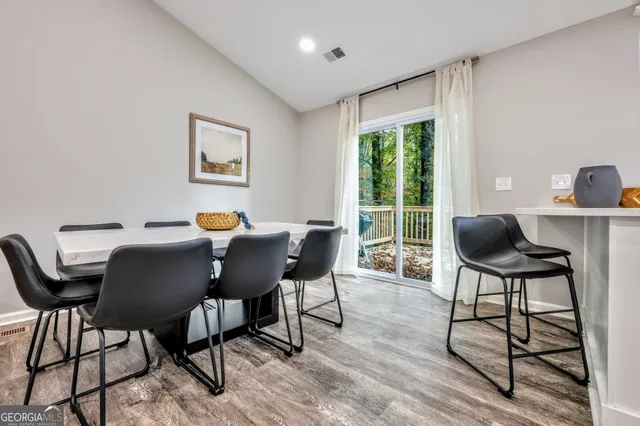 a view of a dining room with furniture window and wooden floor