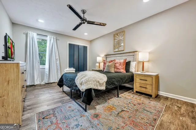 a bedroom with a bed and a lamp on dresser