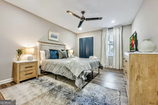 a bedroom with a large bed and a chandelier