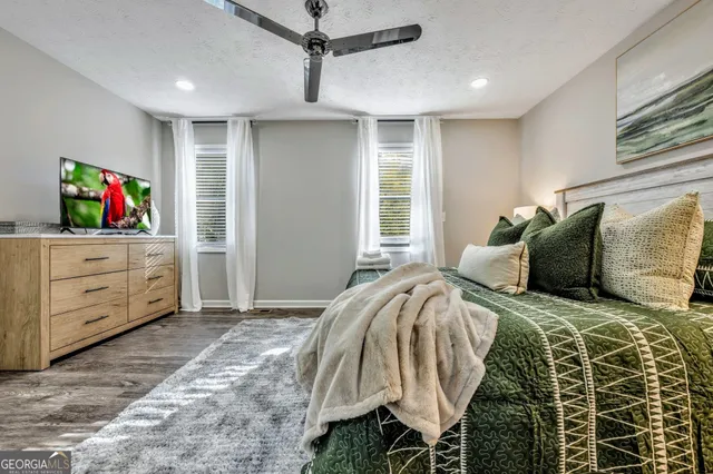 a bedroom with a large bed and a window