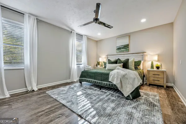 a bedroom with a bed and ceiling fan