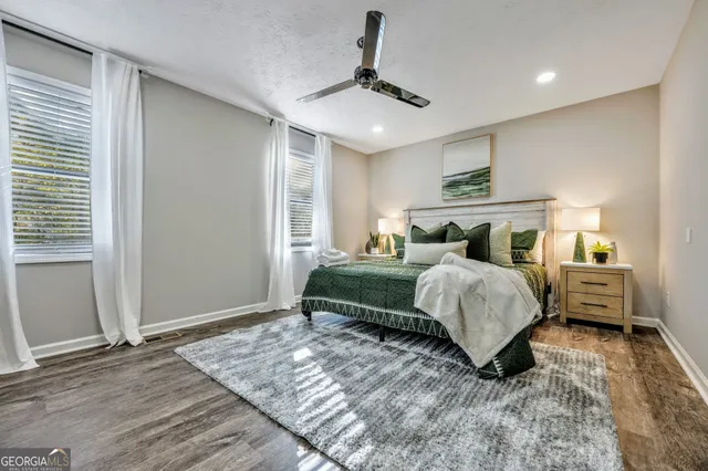 a bedroom with a bed and ceiling fan