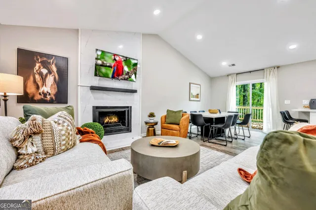 a living room with furniture fireplace and window
