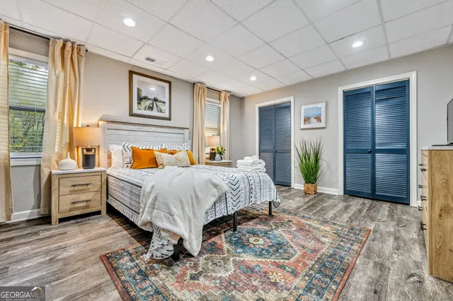 a spacious bedroom with a bed and dresser