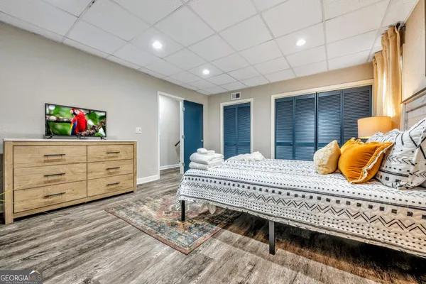 a bedroom with a large bed and a window
