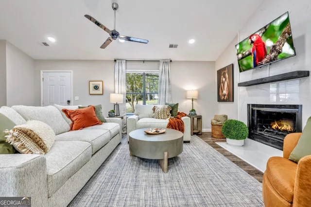 a living room with furniture a window and a fireplace