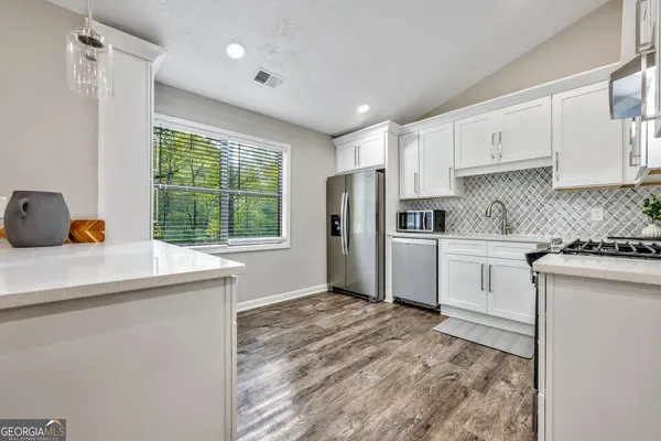 a kitchen with a refrigerator and window