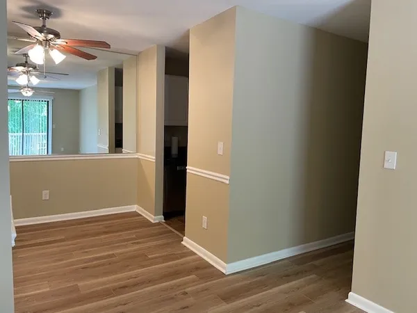 a view of a room with wooden floor