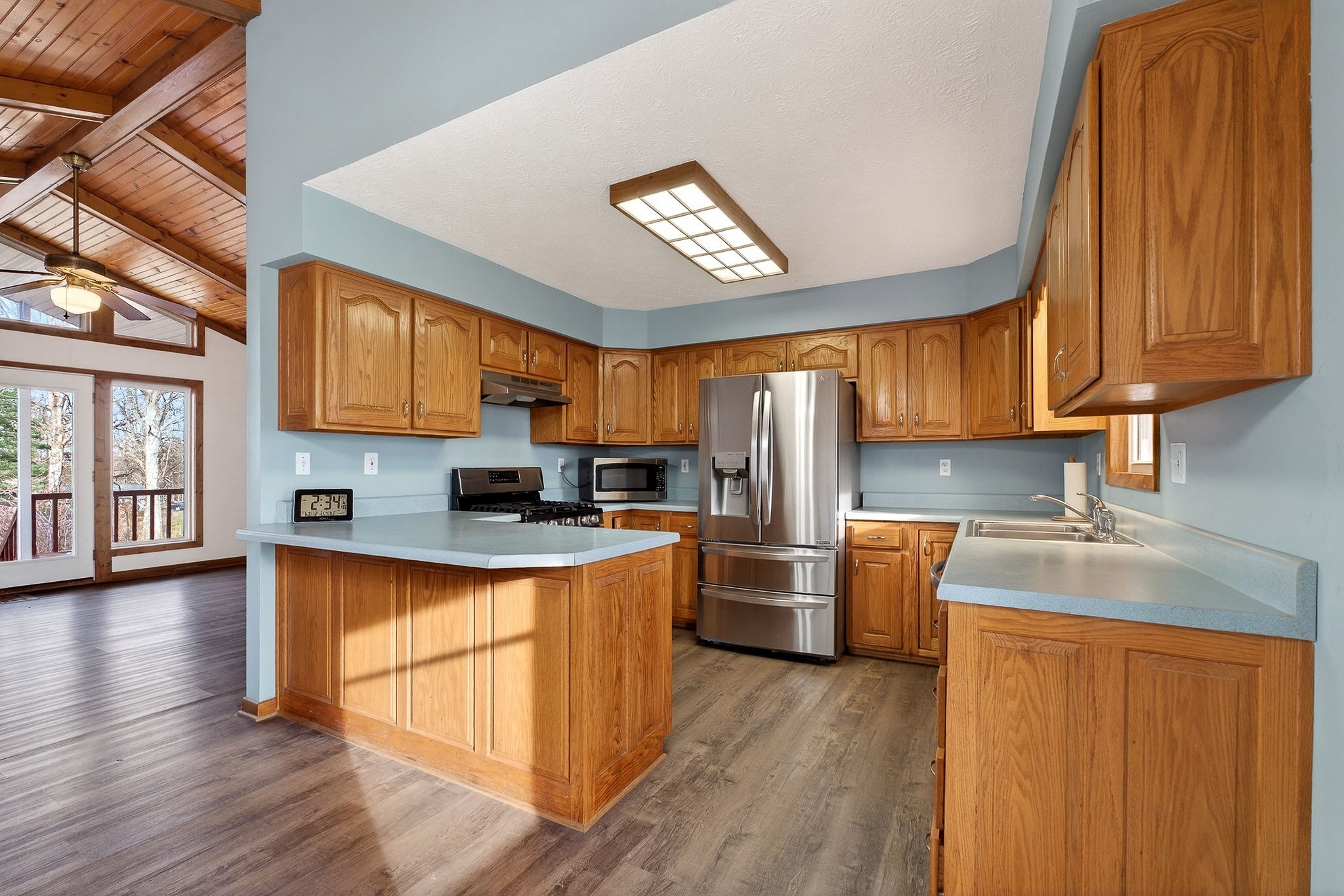 8607 Bockman Way Sparta, TN 38583 - Photo 11 of 34 a large kitchen with stainless steel appliances granite countertop a stove a sink dishwasher and a refrigerator with wooden cabinets