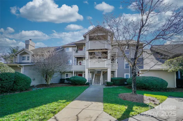 a front view of a house with a garden and yard