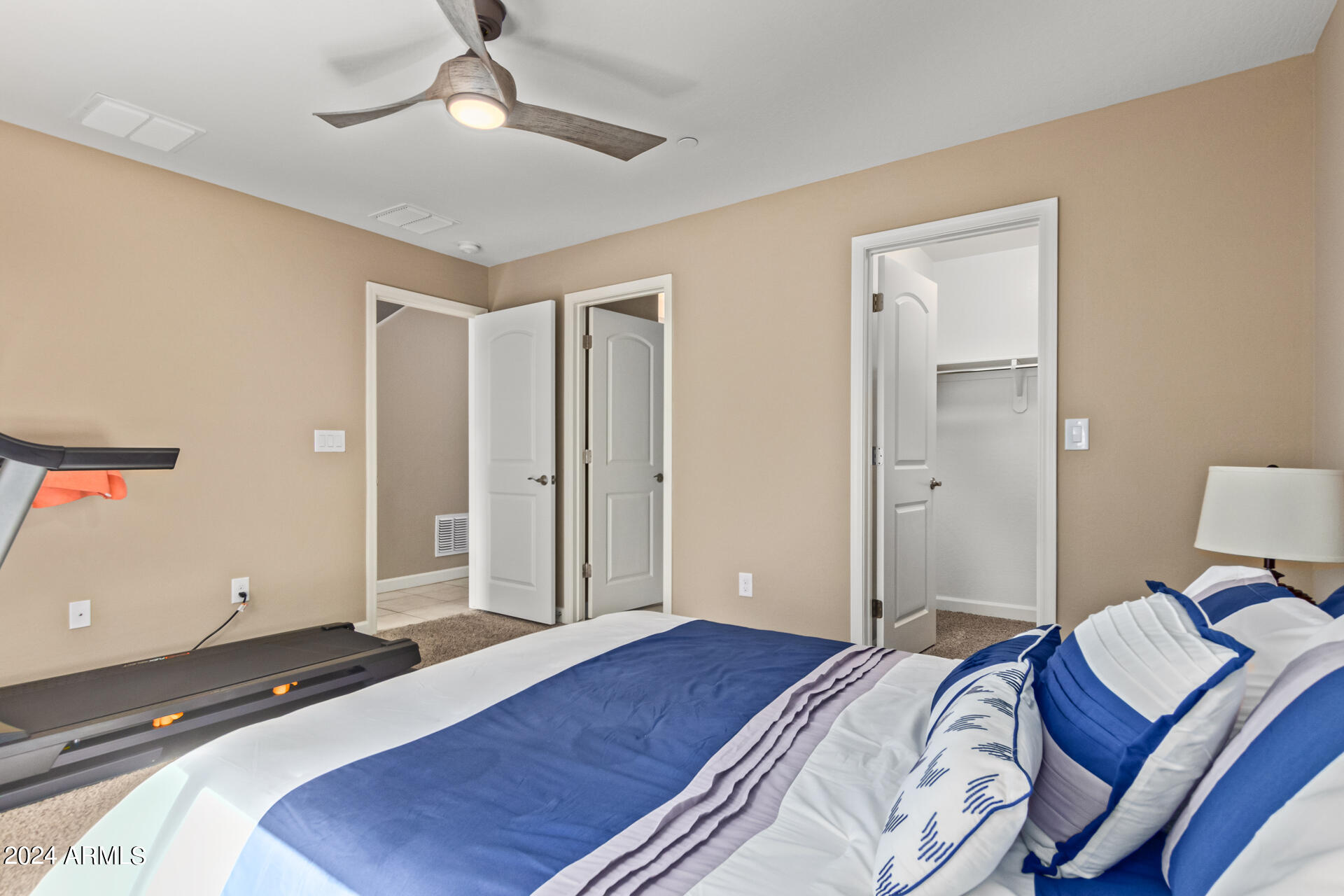 2150 West Alameda Road, Unit 1182 Phoenix, AZ 85085 - Photo 21 of 47 a bedroom with a bed and a chandelier