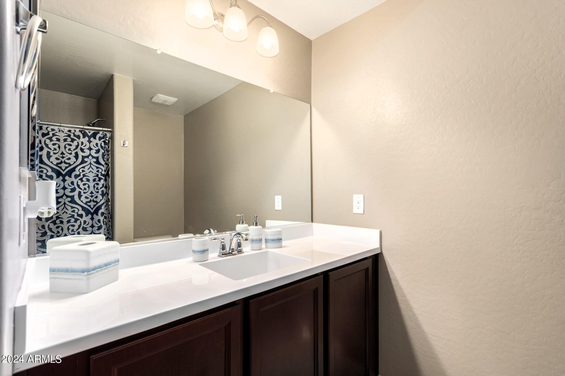 2150 West Alameda Road, Unit 1182 Phoenix, AZ 85085 - Photo 23 of 47 a bathroom with a sink and a mirror