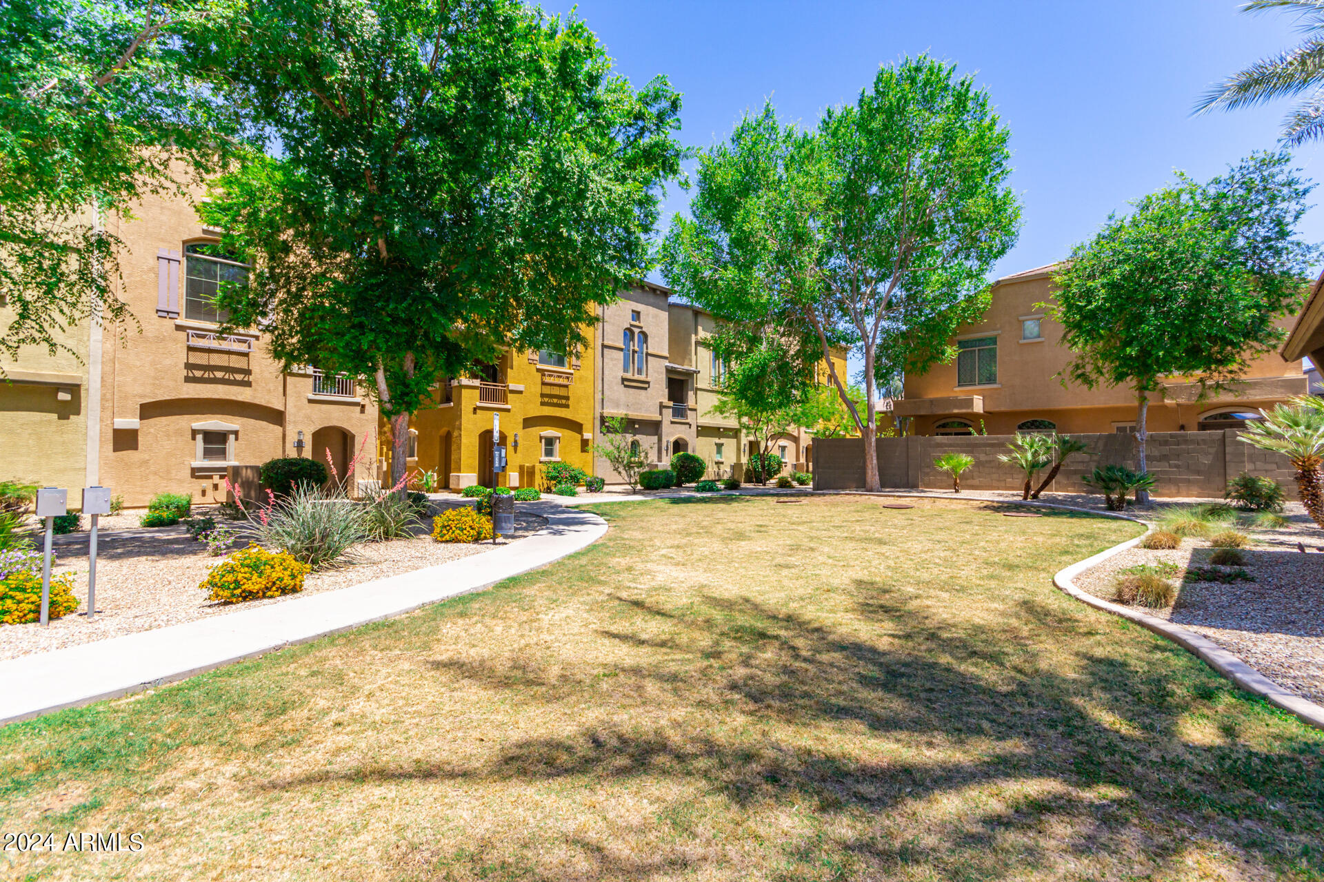 2150 West Alameda Road, Unit 1182 Phoenix, AZ 85085 - Photo 35 of 47 a view of a swimming pool with outdoor seating and a tree