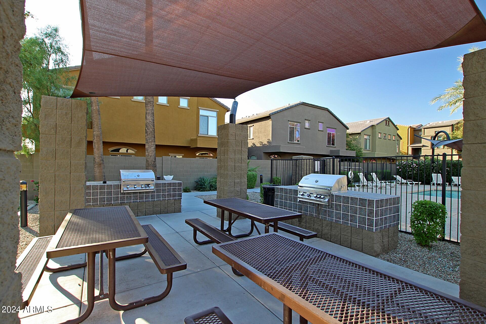 2150 West Alameda Road, Unit 1182 Phoenix, AZ 85085 - Photo 37 of 47 a patio with table and chairs