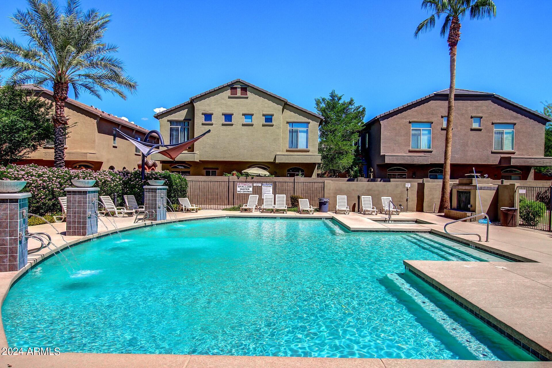 2150 West Alameda Road, Unit 1182 Phoenix, AZ 85085 - Photo 41 of 47 a front view of a house with garden and sitting area