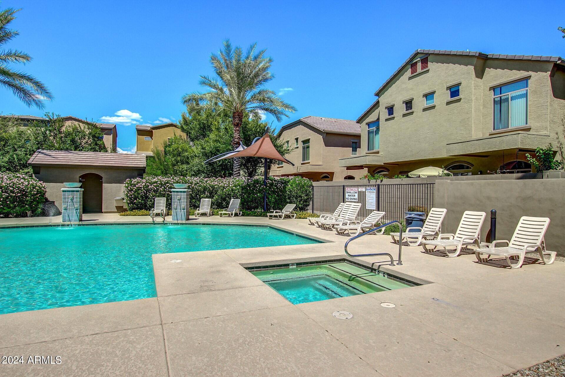 2150 West Alameda Road, Unit 1182 Phoenix, AZ 85085 - Photo 42 of 47 a front view of a house with garden and sitting area