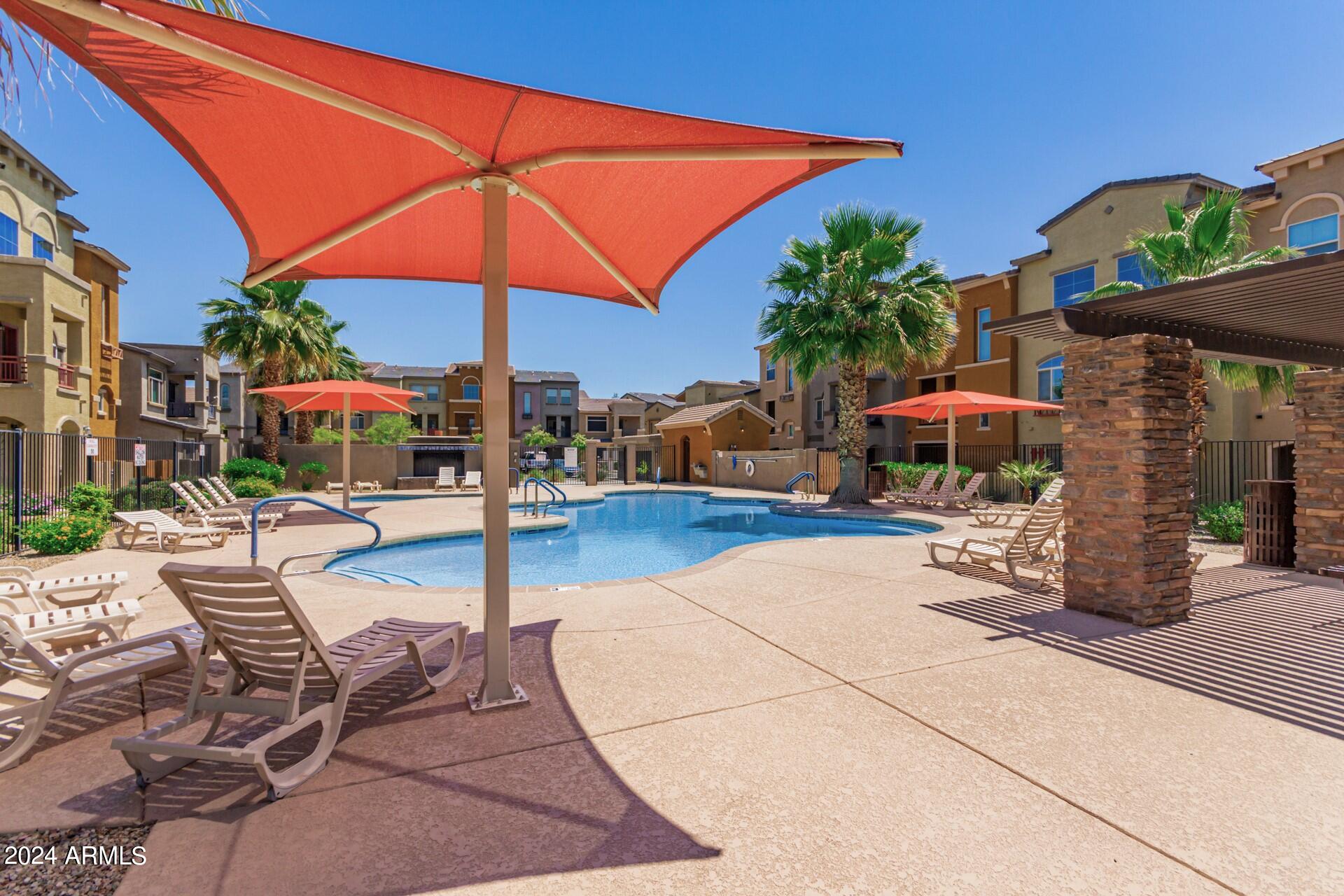 2150 West Alameda Road, Unit 1182 Phoenix, AZ 85085 - Photo 43 of 47 a patio with a table and chairs under an umbrella