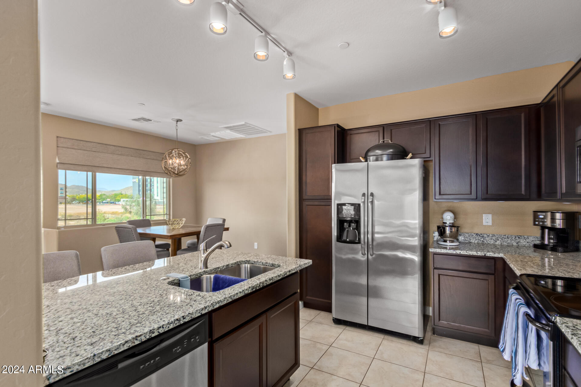 2150 West Alameda Road, Unit 1182 Phoenix, AZ 85085 - Photo 4 of 47 a kitchen with granite countertop a sink a counter space appliances and cabinets