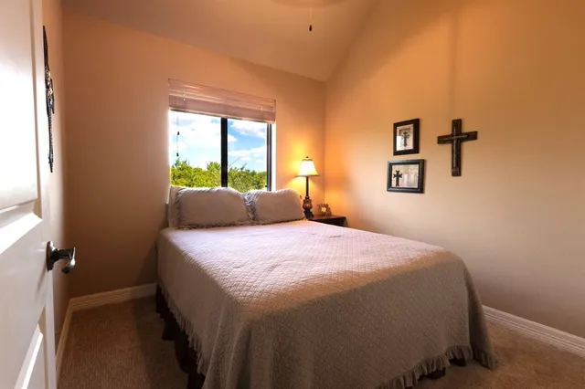 a living room with furniture a large window with wooden floor