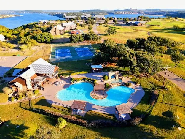 an aerial view of a swimming pool with outdoor seating