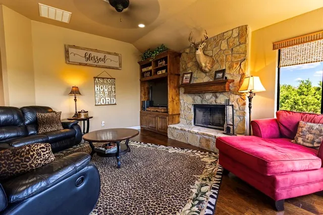 a living room with furniture a flat screen tv and a fireplace