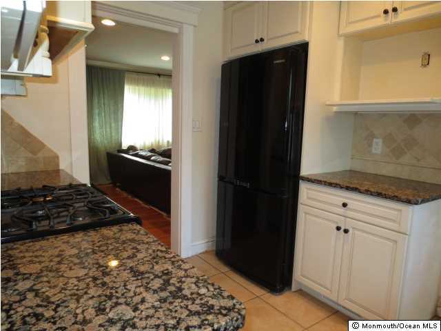 10 Fairmount Road Holmdel, NJ 07733 - Photo 2 of 3 a kitchen with granite countertop a refrigerator and a stove