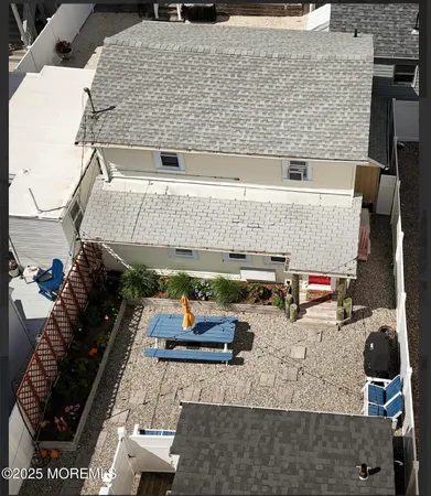 an aerial view of a house with sitting area